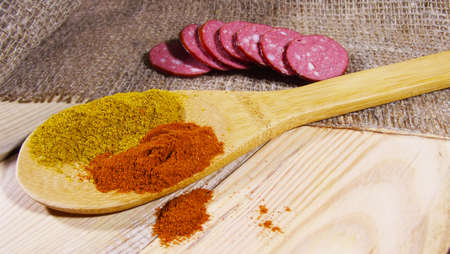 Spices in spoon on wooden background.の写真素材