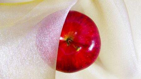 Red Apple on a background of light fabric.の写真素材