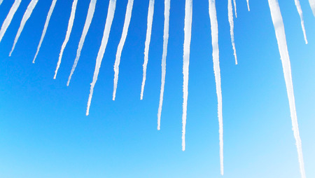 Icicles against the blue sky.の写真素材