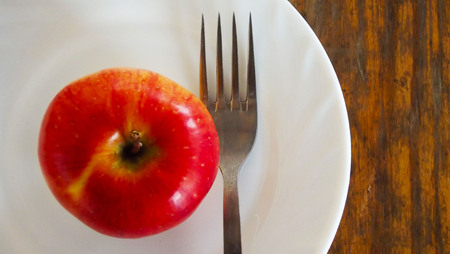 Fresh red Apple on a white plate.の写真素材