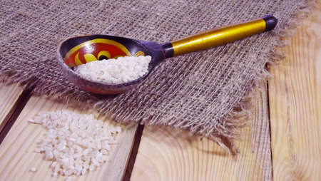 Groats in a wooden spoon.の写真素材