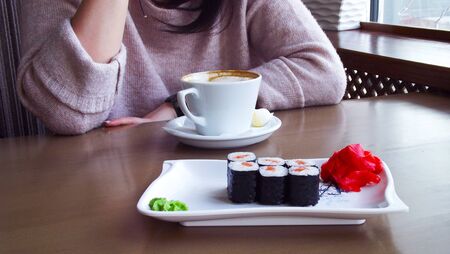Girl drinking coffee in a cafe.の写真素材