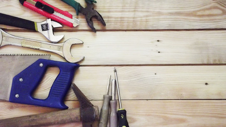 Bench tools on a wooden background.