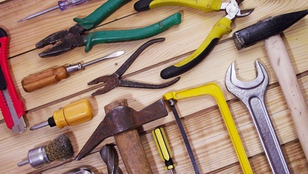 Locksmith tools on wooden background.