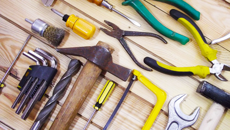 Locksmith tools on wooden background.