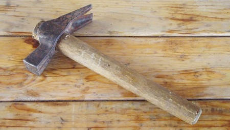 Old knocker on a wooden background.
