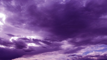 The sun shines through the dark clouds. The natural background.の写真素材