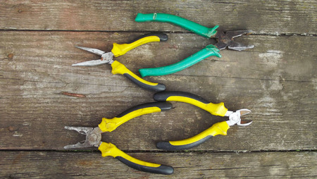 Locksmith tools on wooden background.