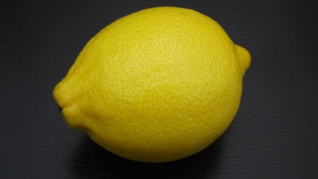 Fresh lemon on black background.の写真素材
