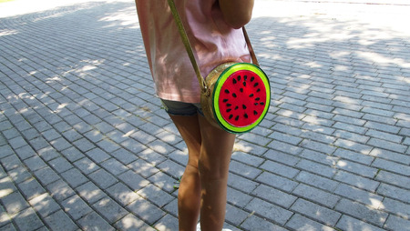 Teen girl with red bag with watermelon pattern.の写真素材