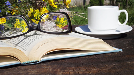 Books on a wooden background.Reading in the fresh air.の写真素材
