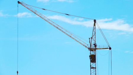 Construction site.Crane on the background of the blue sky.の写真素材