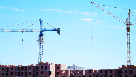 Construction site.Crane on the background of the blue sky.の写真素材