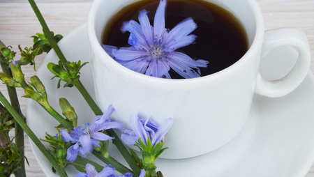 Delicious and healthy beverage from chicory, on wooden background.の写真素材