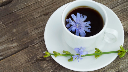 Delicious and healthy beverage from chicory, on wooden background.の写真素材