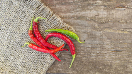 Hot chili pepper on wooden background.の写真素材