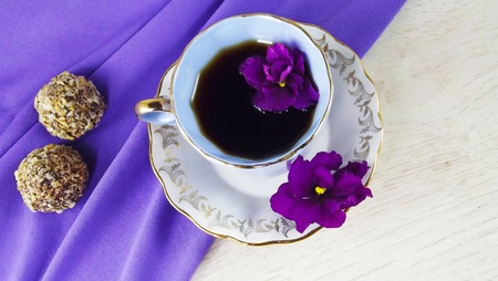 Cup of coffee on a purple background.