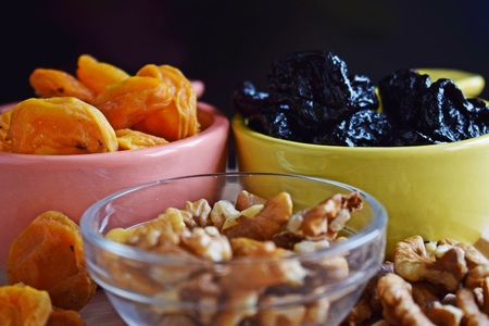 Useful dried fruits and walnuts on wooden background.の写真素材