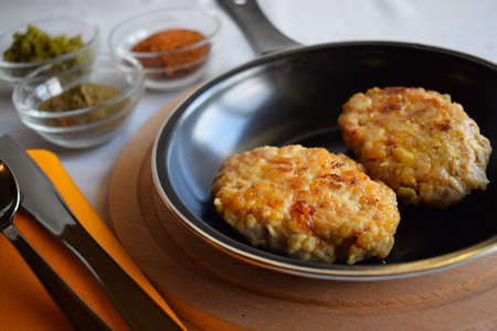 Delicious fried cutlets with spices in a frying pan.の写真素材