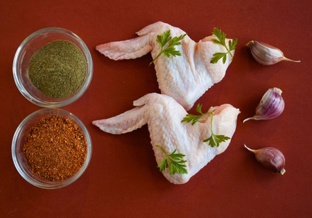 Fresh chicken wings for frying on wooden background.の写真素材