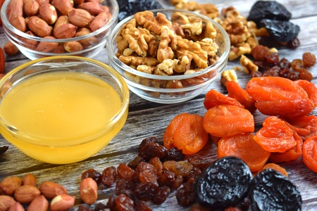 Dried fruits and honey on wooden background.Healthy.の写真素材