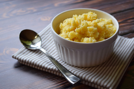 Useful cornmeal porridge on wooden background.の写真素材