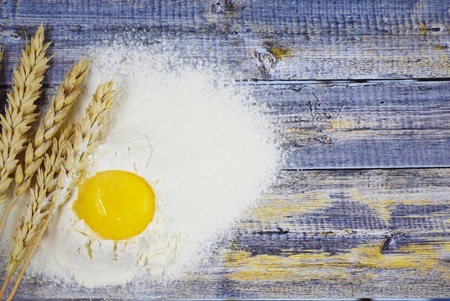 Dough prepartion. Egg and flour on wooden background.の写真素材