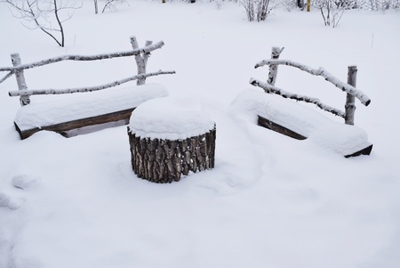 Bench under the snow in winter.の写真素材