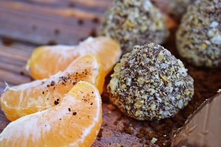 Chocolates, cocoa and fresh tangerines on wooden background.の写真素材