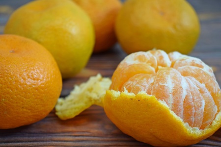 Ripe useful tangerines on wooden background.の写真素材