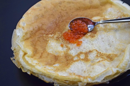 Delicious fresh pancakes and caviar in a spoon.の写真素材
