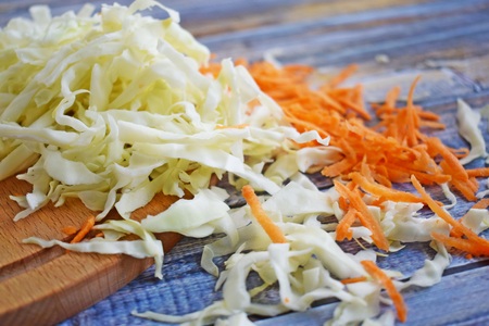 Sliced carrots and cabbage on a wooden Board.Food ingredient.の写真素材