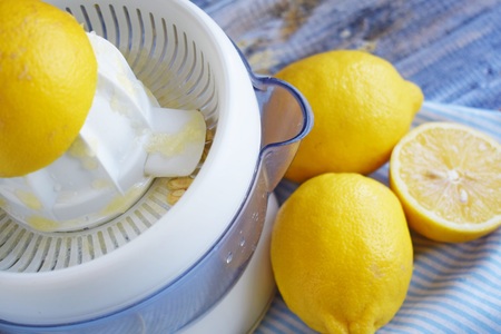 Fresh lemons and citrus juice on wooden background.の写真素材