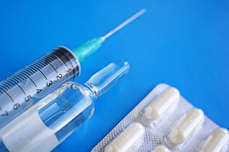 Medical preparation.Syringe on blue background.の写真素材