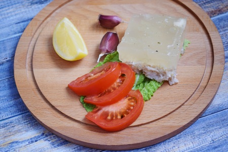 Aspic of chicken and vegetables on wooden background.