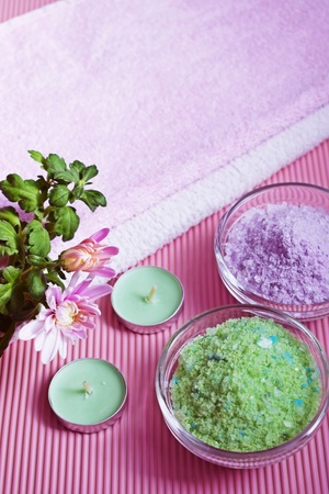 Colorful bath salt on pink background. Healthy skin care.の写真素材