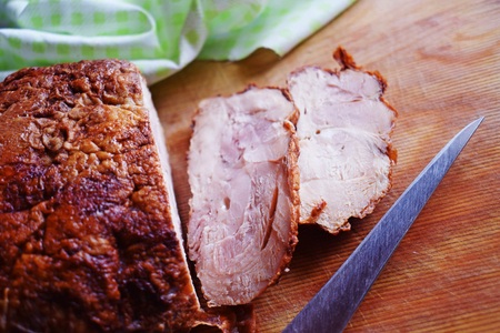 Delicious baked meat on a wooden Board.の写真素材