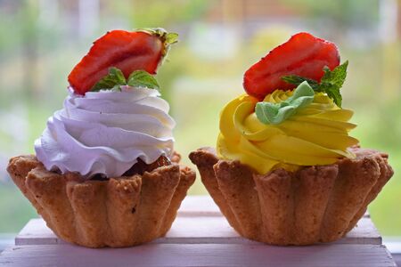 Delicious cakes baskets of short pastry with jam and cream.の写真素材