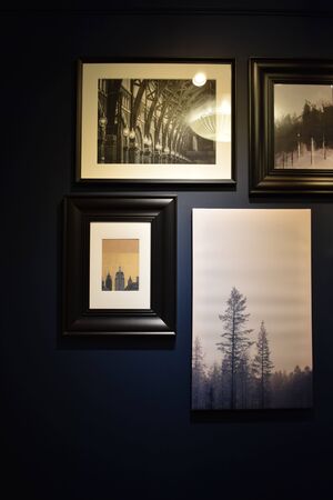 Wall with photos on a dark background.Interior design
