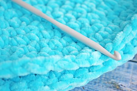 Turquoise knitted round carpet or rug. Antique handmade carpet. Home hobby.