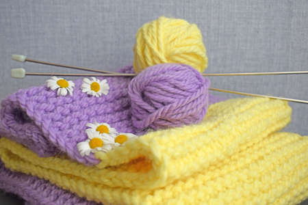 A warm lilac-yellow scarf, knitted with thick yarn.Handmade work.