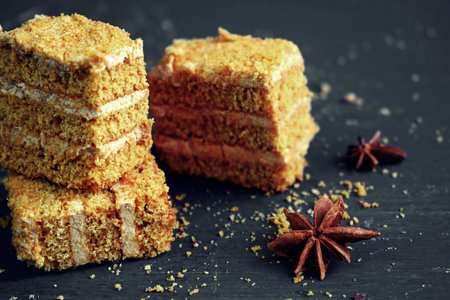 Delicious honey cake on a black background.の写真素材