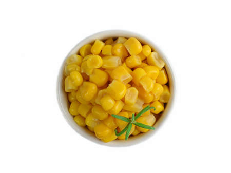Canned corn in a white dish on a white background.