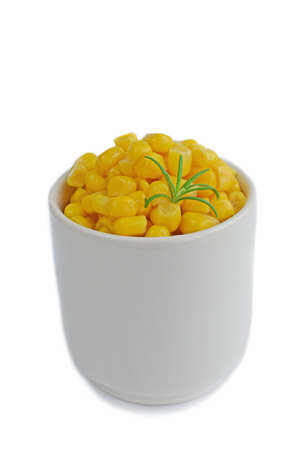 Canned corn in a white dish on a white background.の写真素材
