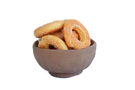 Sugar cookies in an old clay plate on a white background.