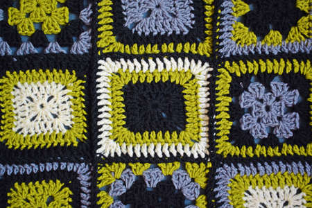 Knitted background.Abstract knitted pattern.Green and gray square pattern.