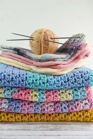 Yarn for knitting, knitting needles.Handmade knitted items on a white background.Hobby.
