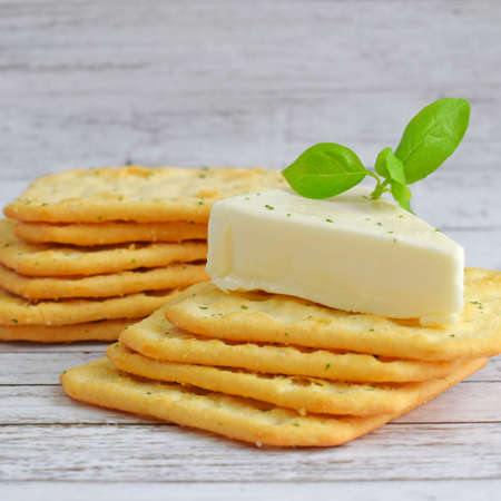 Crackers with butter and herbs on a wooden background. Selective focus.の写真素材