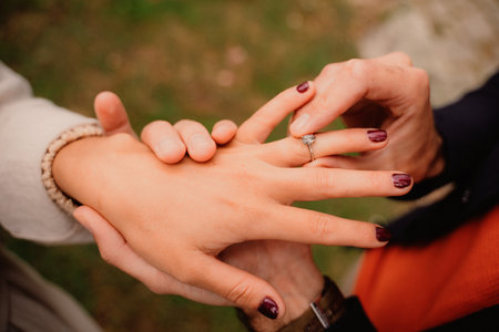 Man places engagement ring on his beloveds handの写真素材