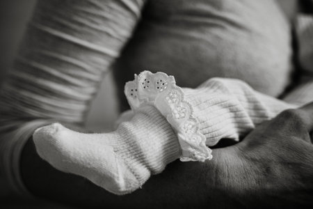 Gentle scene of a mother tenderly holding her sleeping child, showing the warmth and intimacy of family bonds. The focus is on the affectionate embrace and calming atmosphereの写真素材